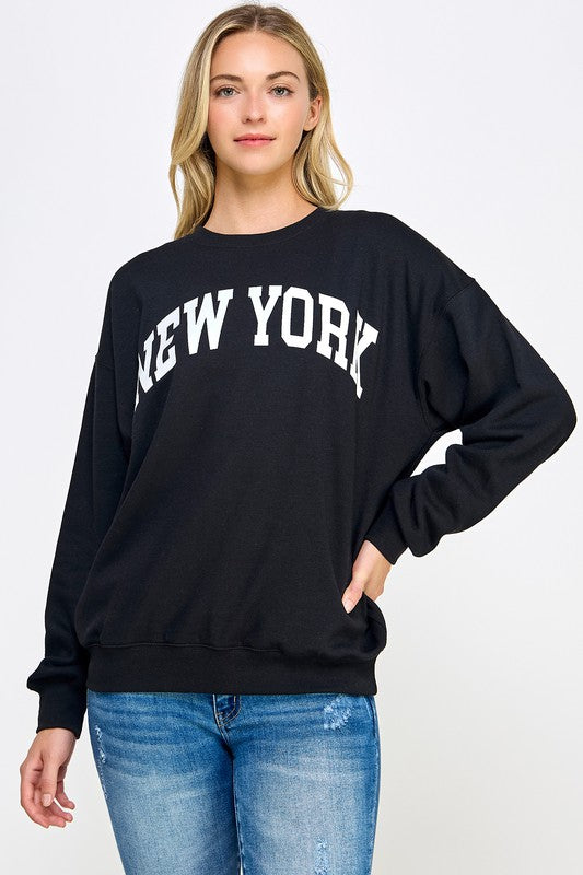 Black crew neck sweatshirt with New York in white letters.