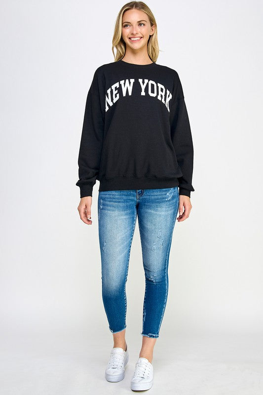 Black crew neck sweatshirt with New York in white letters.