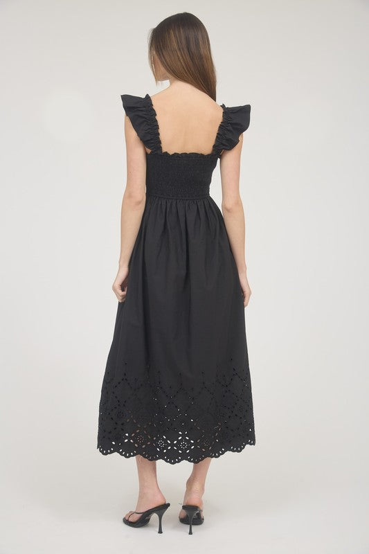 Back of black smocked eyelet dress with ruffle straps and smocked bodice – boutique style.