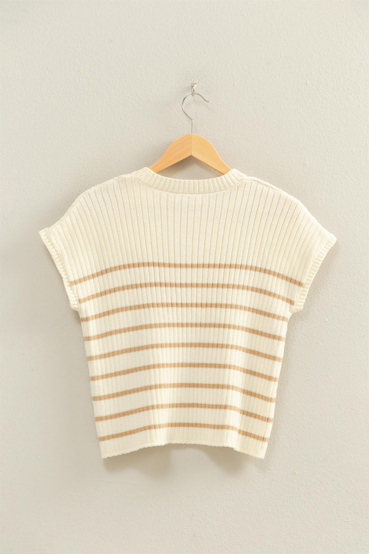 Striped sweater on a hanger against a plain background