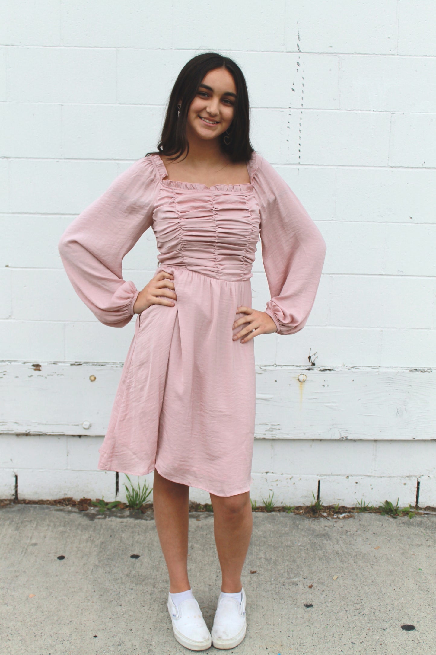 Blush pink ruffled top dress with long sleeves and pockets, knee length.