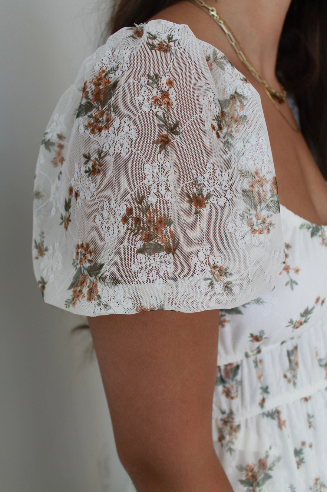 Close-up of a floral lace top with a blurred background