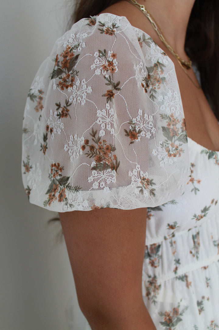 Close-up of a floral lace top with a blurred background