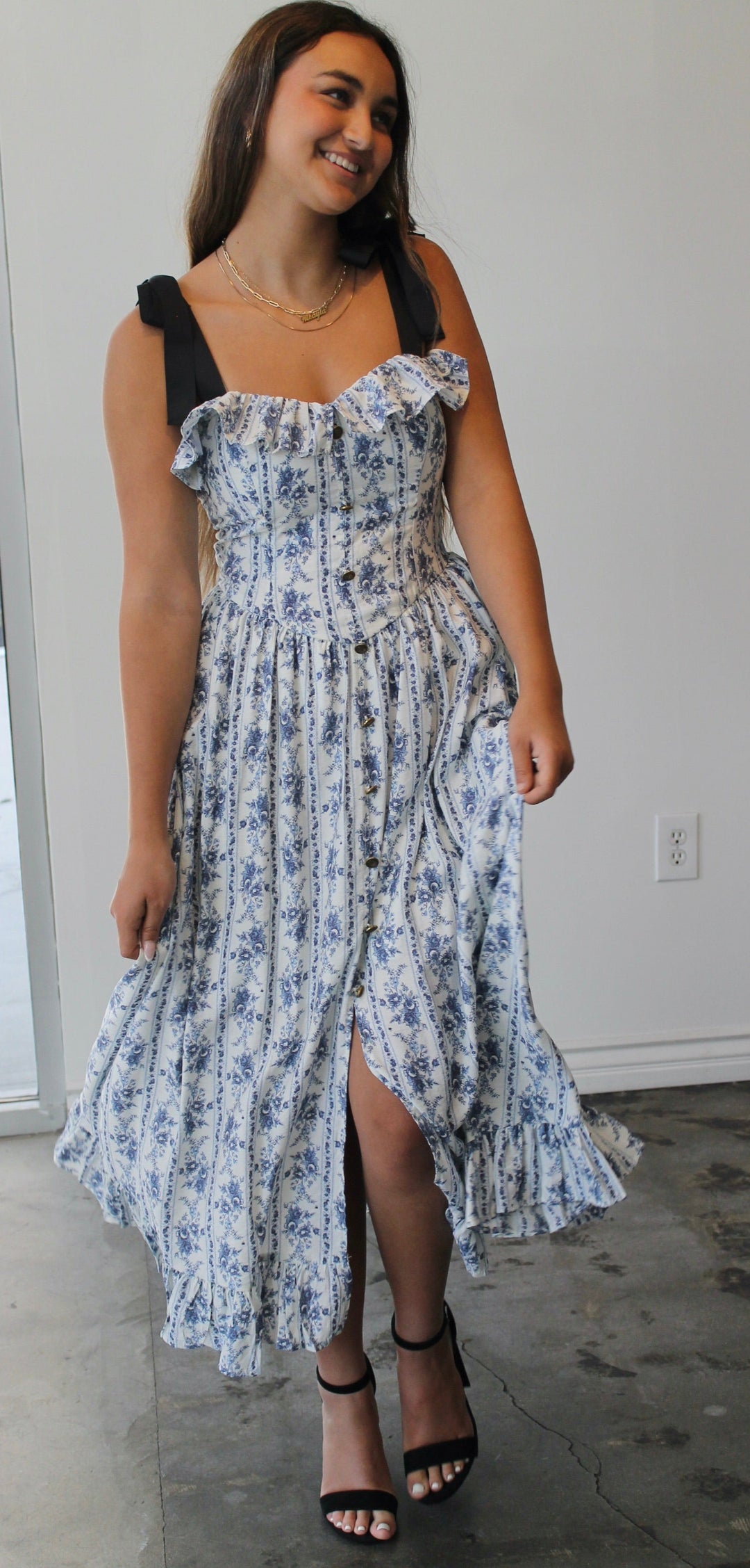 Woman wearing a floral dress in an indoor setting