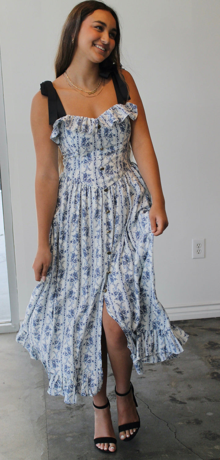 Woman wearing a floral dress in an indoor setting