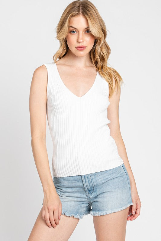 Model wearing white ribbed knit V-neck sleeveless top from AndyLiz Boutique in Long Beach California store