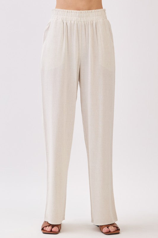 Front view of beige linen wide leg pants with elastic waistband